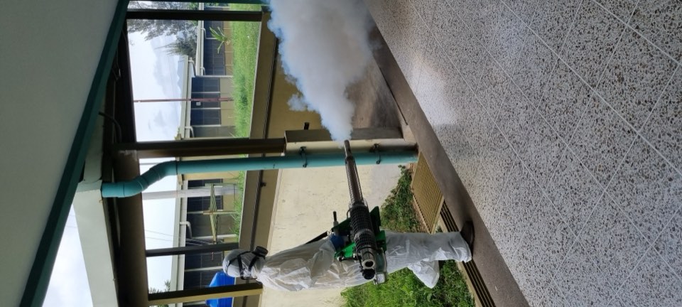 EcoPlagas technician applying treatment in protective gear