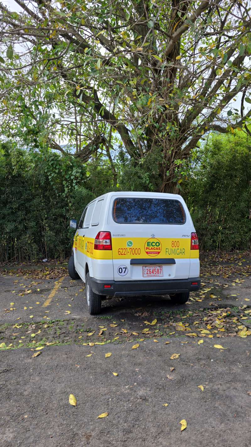 Branded EcoPlagas 800-FUMIGAR van parked at a job site