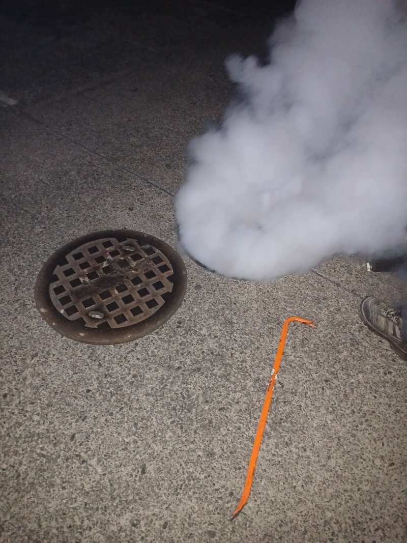Fog from treatment coming out of a storm drain during drain fogging